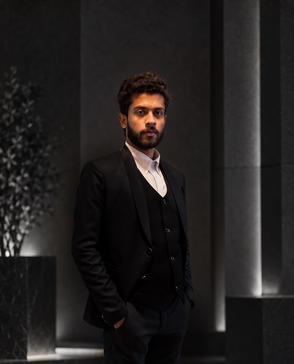 Rahul Ravikant Mishra, Founder, Helius Marketing Agency, in a dark suit against a charcoal architectural setting.